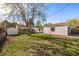 Spacious backyard featuring a garage, home, outbuilding and mature tree at 3430 N Clayton St, Denver, CO 80205