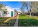 Green backyard with a detached garage and a concrete path leading to the garage at 3430 N Clayton St, Denver, CO 80205