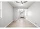 Spacious bedroom features light hardwood floors, fan, and a window offering great natural light at 3430 N Clayton St, Denver, CO 80205