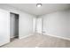 Well-lit bedroom boasting laminate floors, neutral walls, white trim, and two white doors at 3430 N Clayton St, Denver, CO 80205