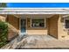 Close-up of a charming front porch featuring brick facade, awnings, and secure storm door at 3430 N Clayton St, Denver, CO 80205