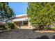 Attractive single-story brick home with manicured landscaping and mature trees, close to the sidewalk at 3430 N Clayton St, Denver, CO 80205