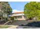 Attractive single-story brick home with tidy landscaping and mature trees, close to the road at 3430 N Clayton St, Denver, CO 80205