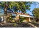 Inviting single-story brick home with manicured landscaping, lush trees, and well-maintained lawn at 3430 N Clayton St, Denver, CO 80205