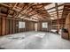 Large unfinished garage with exposed wood framing, concrete floor, shelving, and a window at 3430 N Clayton St, Denver, CO 80205