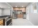 Modern kitchen features stainless steel appliances, sleek countertops, and updated cabinetry at 3430 N Clayton St, Denver, CO 80205