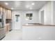 Bright kitchen featuring stainless steel appliances, white tile flooring, and light wood cabinets at 3430 N Clayton St, Denver, CO 80205