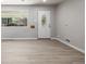 Light filled living room with updated flooring, trim and white front door with glass at 3430 N Clayton St, Denver, CO 80205