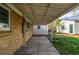 Covered brick patio attached to the house with a cement floor and view of the backyard at 3430 N Clayton St, Denver, CO 80205