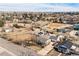 Aerial view of the property including a home, multiple horse stalls, sheds and an outdoor arena at 1930 Altura Blvd, Aurora, CO 80011