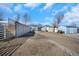 Backyard featuring a fenced yard, multiple storage sheds and a parking area at 1930 Altura Blvd, Aurora, CO 80011