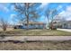 Charming single-story home with a well-maintained front yard and mature trees, offering great curb appeal at 1930 Altura Blvd, Aurora, CO 80011