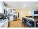 Open-concept kitchen and dining area with stainless steel appliances at 1930 Altura Blvd, Aurora, CO 80011