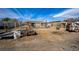 Large lot with fencing, sheds, and machinery on the property at 1930 Altura Blvd, Aurora, CO 80011