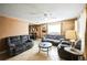 Spacious living room with tile floors, neutral colors, and a ceiling fan for added comfort at 1930 Altura Blvd, Aurora, CO 80011