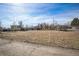 Large, fenced yard with plenty of open space and a well-maintained lawn at 1930 Altura Blvd, Aurora, CO 80011