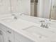 Modern bathroom features double vanity with quartz countertops and chrome fixtures at 564 Red Rock Pl, Brighton, CO 80601