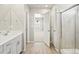 Bathroom featuring wood-look flooring, modern vanity, and glass enclosed shower at 564 Red Rock Pl, Brighton, CO 80601