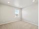 Bedroom with carpeted floor and view of a neighborhood through the window at 564 Red Rock Pl, Brighton, CO 80601