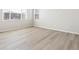 Bright bedroom showcasing new hardwood floors, white walls, and a large window at 564 Red Rock Pl, Brighton, CO 80601