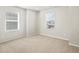 Bright bedroom with neutral walls and carpet, and windows with blinds at 564 Red Rock Pl, Brighton, CO 80601