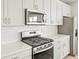 Modern kitchen features stainless steel appliances, quartz countertops, and a subway tile backsplash at 564 Red Rock Pl, Brighton, CO 80601