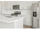 Modern kitchen with stainless steel appliances, quartz countertop, and white subway tile backsplash at 564 Red Rock Pl, Brighton, CO 80601