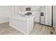 Bright kitchen island with stainless steel appliances, quartz countertop, and white subway tile backsplash at 564 Red Rock Pl, Brighton, CO 80601