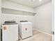 Laundry room with newer washer and dryer at 564 Red Rock Pl, Brighton, CO 80601