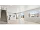 Bright and airy living room flowing into the kitchen with stainless appliances and a kitchen island at 564 Red Rock Pl, Brighton, CO 80601