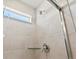 Tiled shower stall with glass door and chrome showerhead at 564 Red Rock Pl, Brighton, CO 80601