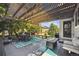 Covered back patio features a dining area and outdoor seating beneath a pergola at 14049 Detroit Dr, Thornton, CO 80602