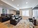 Finished basement boasts a home movie theater with leather recliners and a large screen TV at 14049 Detroit Dr, Thornton, CO 80602