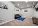 Basement room with neutral carpet, a black leather futon, and a mounted TV at 14049 Detroit Dr, Thornton, CO 80602