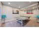 Finished basement boasts a fun area with Ping Pong table and colorful, decorative seating at 14049 Detroit Dr, Thornton, CO 80602