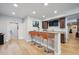 Finished basement features a wet bar with seating, hardwood floors and a TV at 14049 Detroit Dr, Thornton, CO 80602