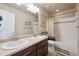 This bathroom features double sinks, a full tub/shower, and ample storage and natural light at 14049 Detroit Dr, Thornton, CO 80602