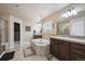Lovely bathroom with a jacuzzi style tub between two sink vanities with tile flooring at 14049 Detroit Dr, Thornton, CO 80602