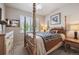 Comfortable bedroom with a four poster bed and neutral tones, perfect for relaxation at 14049 Detroit Dr, Thornton, CO 80602