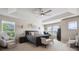 Serene bedroom with a ceiling fan, tray ceilings and a sitting area by the window at 14049 Detroit Dr, Thornton, CO 80602