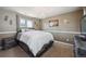 Comfortable bedroom is tastefully decorated and is highlighted by a modern chandelier and ample natural light at 14049 Detroit Dr, Thornton, CO 80602