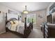Bedroom boasts a large bed with decorative pillows, a window and stylish decor at 14049 Detroit Dr, Thornton, CO 80602
