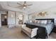 Elegant primary bedroom featuring a luxurious bed and direct access to an en-suite bathroom at 14049 Detroit Dr, Thornton, CO 80602