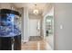 Bright entryway featuring hardwood floors, a modern chandelier, and a unique fish tank at 14049 Detroit Dr, Thornton, CO 80602