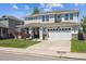 Charming two-story home with a landscaped front yard, covered porch, and a two-car garage at 14049 Detroit Dr, Thornton, CO 80602