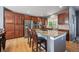 Modern kitchen with stainless steel appliances, granite countertops and a large island at 14049 Detroit Dr, Thornton, CO 80602