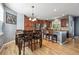 Eat-in kitchen with wood cabinets, stainless steel appliances, and hardwood floors at 14049 Detroit Dr, Thornton, CO 80602