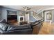Spacious living room with hardwood floors, a fireplace, and an open staircase at 14049 Detroit Dr, Thornton, CO 80602