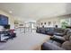 Open living area with a large sectional sofa, desk, and an upstairs view at 14049 Detroit Dr, Thornton, CO 80602