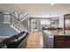 Open-concept living room showcasing a staircase, hardwood floors, and kitchen access at 14049 Detroit Dr, Thornton, CO 80602